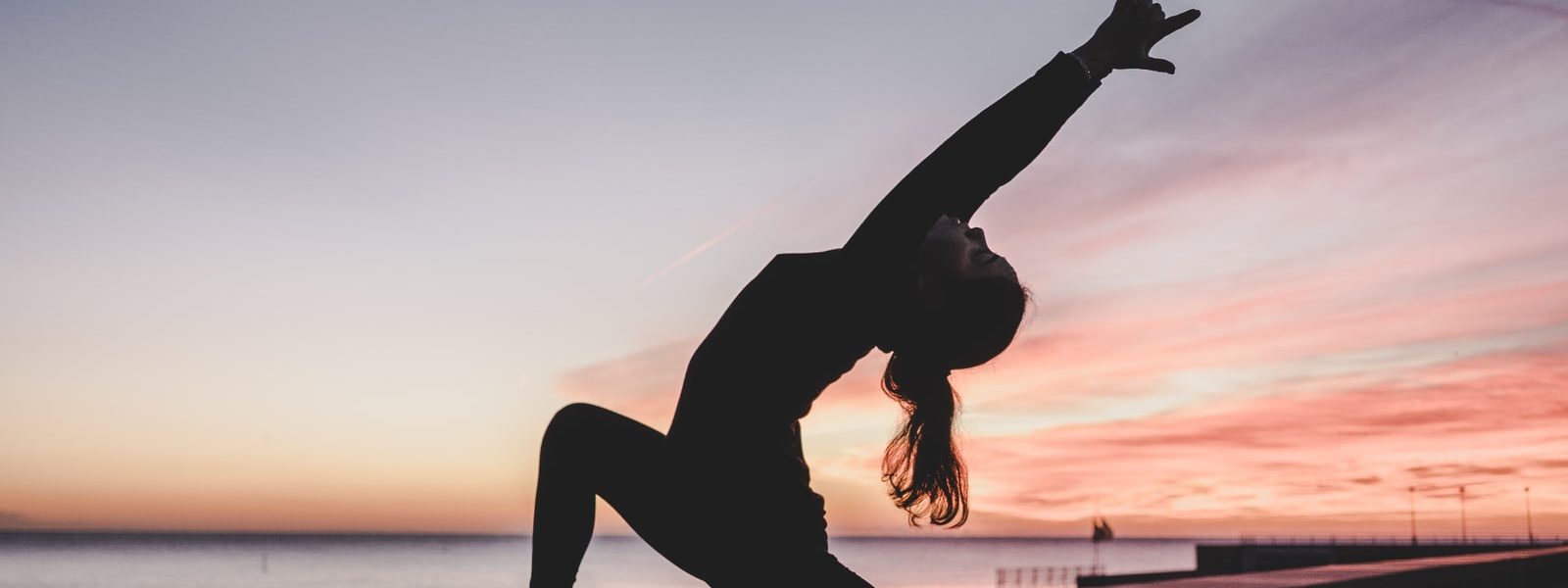 silhouette photography of woman doing yoga