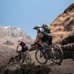 un couple de personnes faisant du vélo sur un chemin de terre